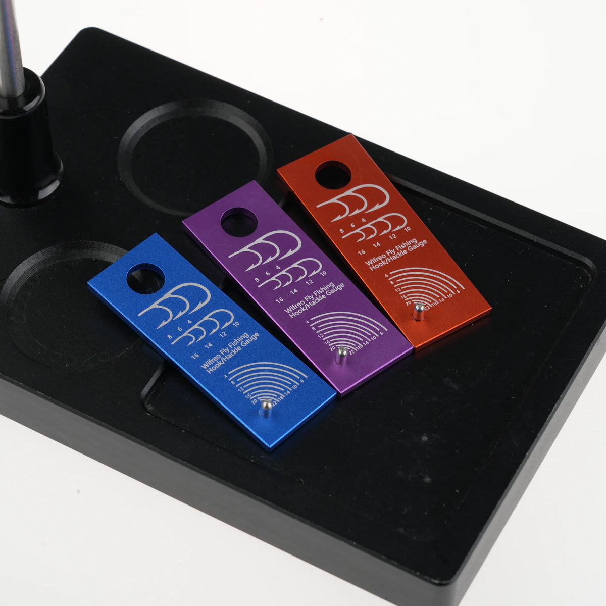Anodized aluminum hook and hackle gauge positioned on a fly tying vise post