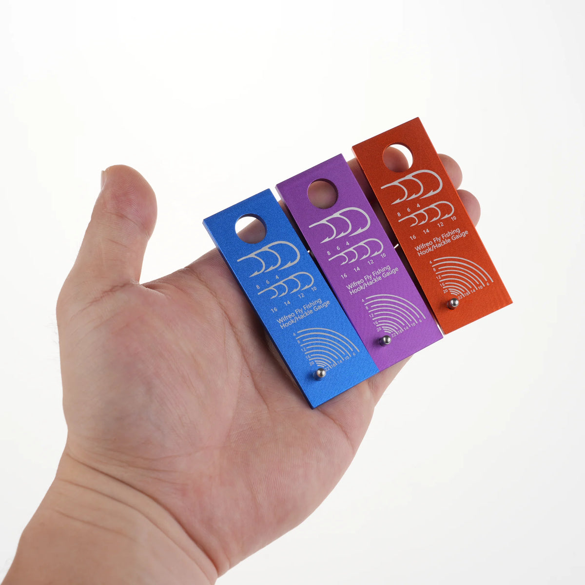 Compact WIFREO hook and hackle gauge shown in hand
