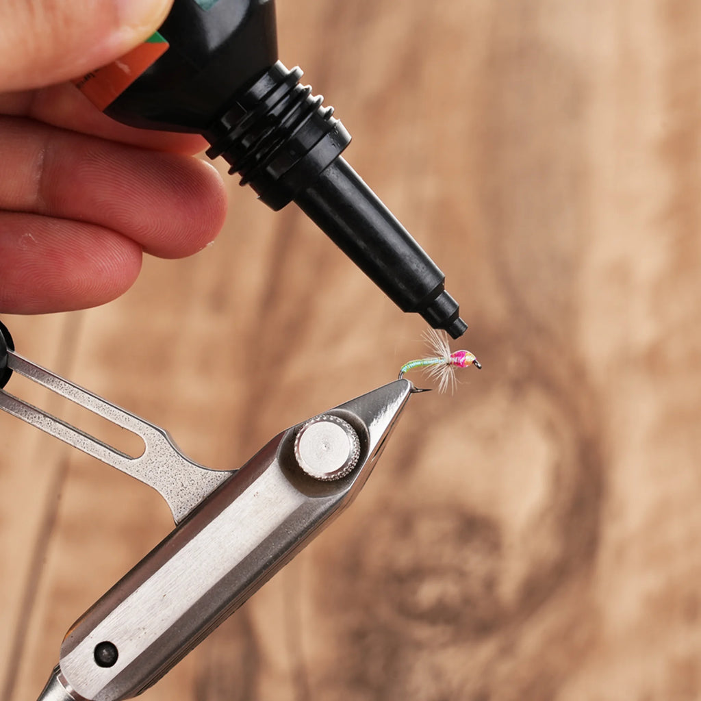 Applying WIFREO UV Clear Fly Finish to a fly held in tying pliers