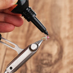 Applying WIFREO UV Clear Fly Finish to a fly held in tying pliers