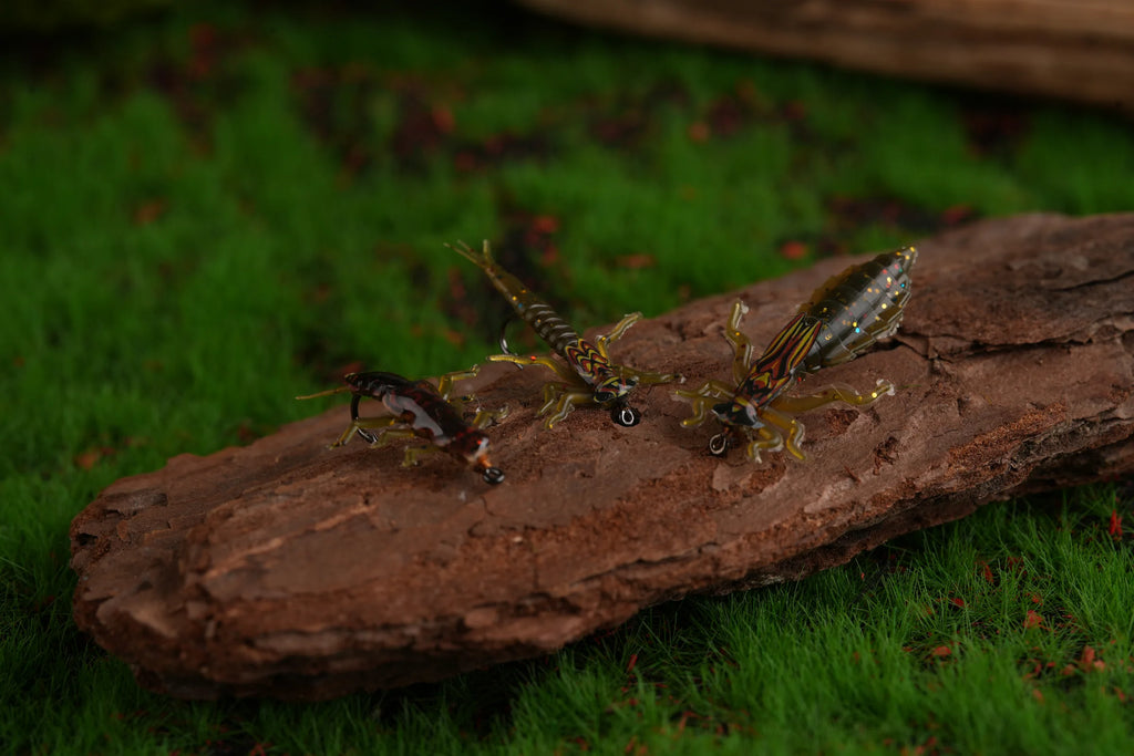Three realistic stonefly nymph tying examples on wood and moss