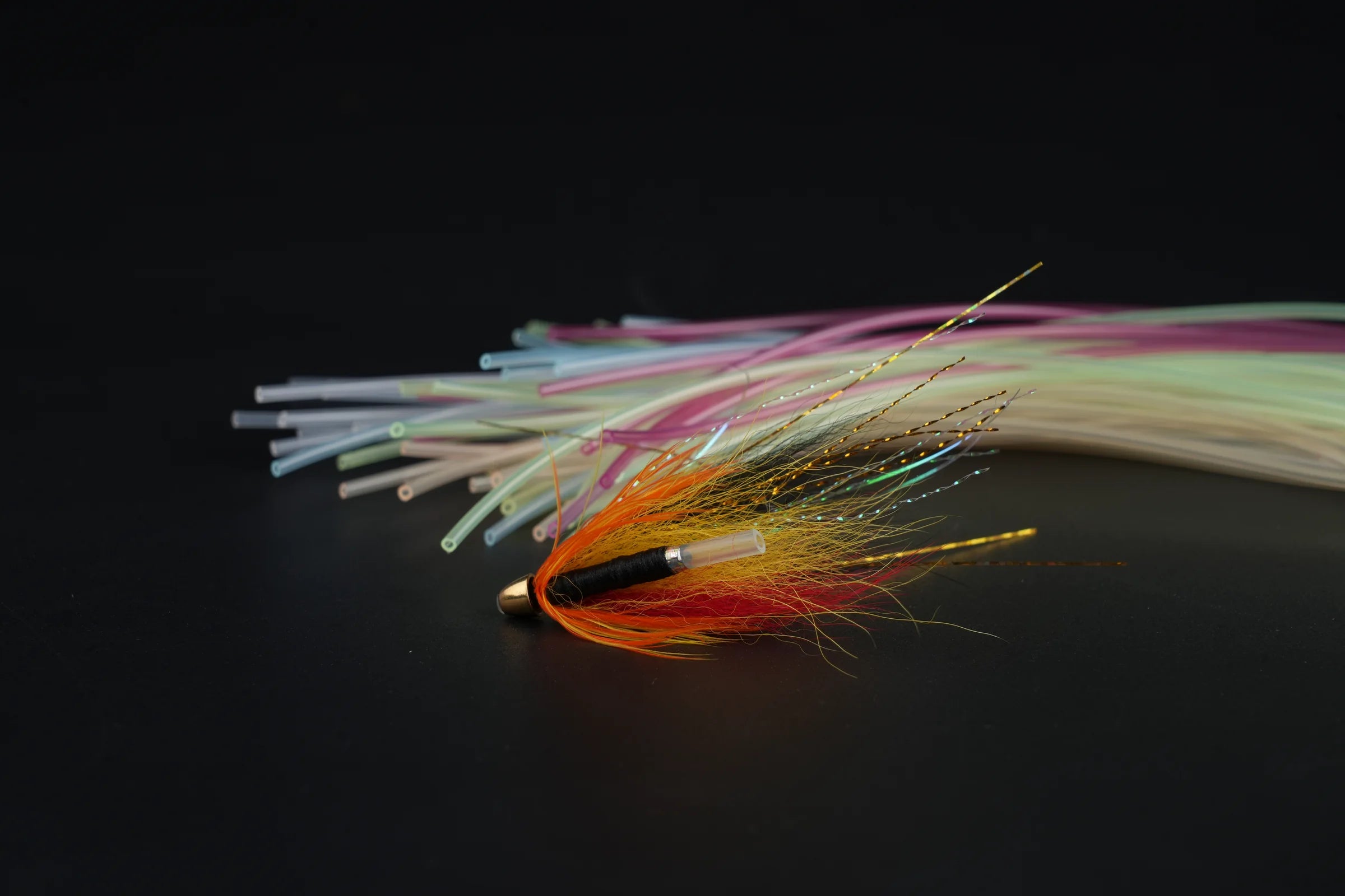 Finished salmon tube fly tying example with colored plastic tubes